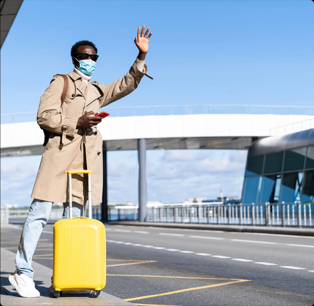 A passenger with a suitcase waving
